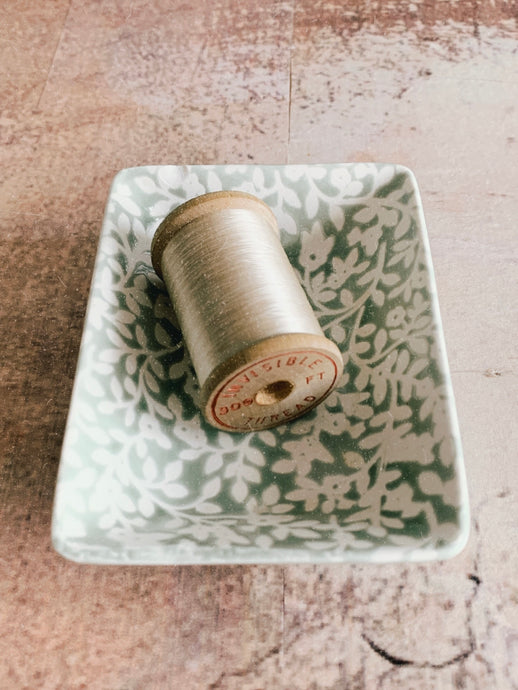 A vintage wooden thread spool - Invisible thread