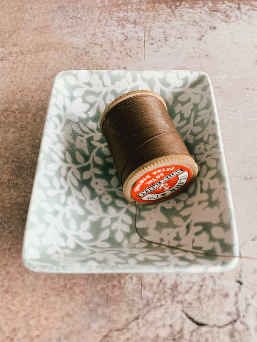 A vintage wooden thread spool - Brown button thread