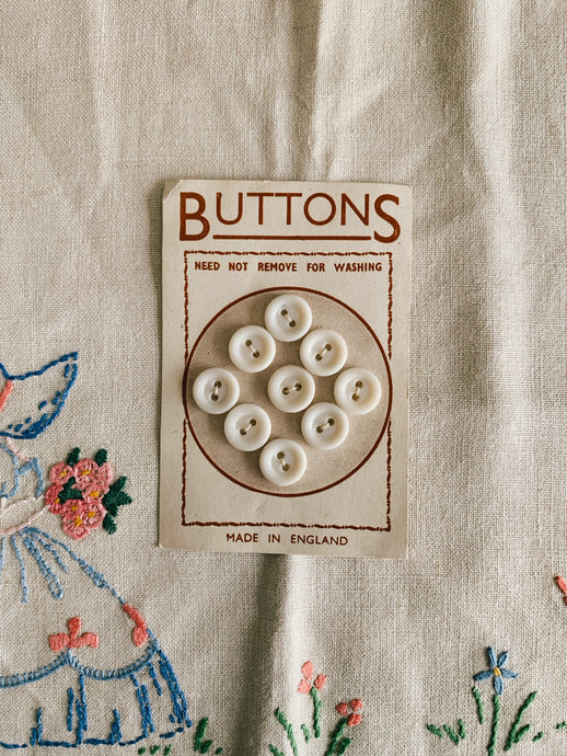 Set of nine vintage buttons on card