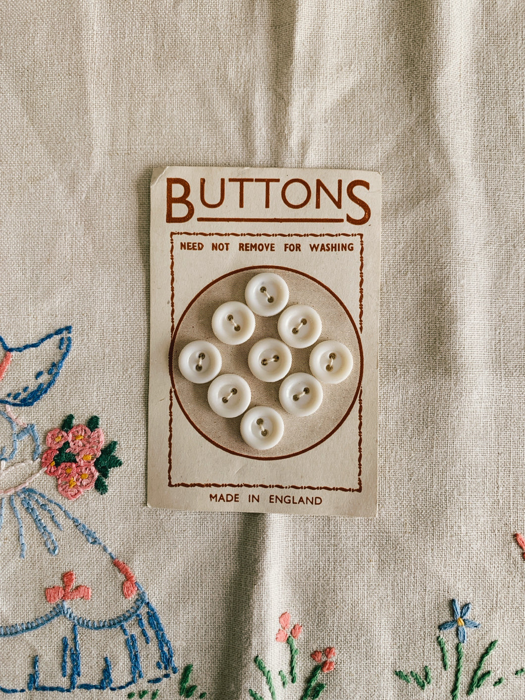 Set of nine vintage buttons on card